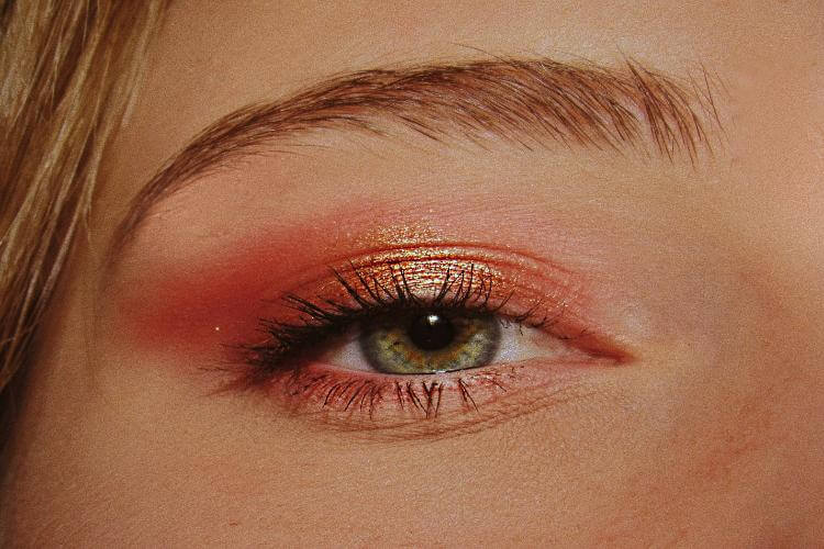 an eye with gold and pink eyeshadow