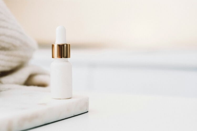 minimalist photo of a serum bottle and dropper
